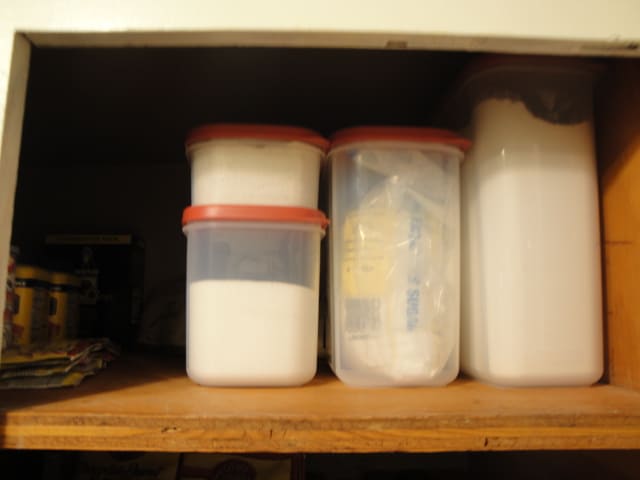 Rubbermaid Tupperware full of flour, sugar, and rice.