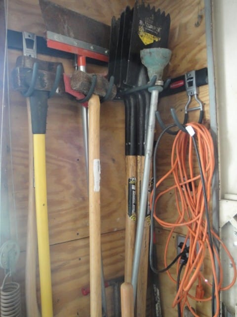 Brooms, Shovels, cords, in garage.