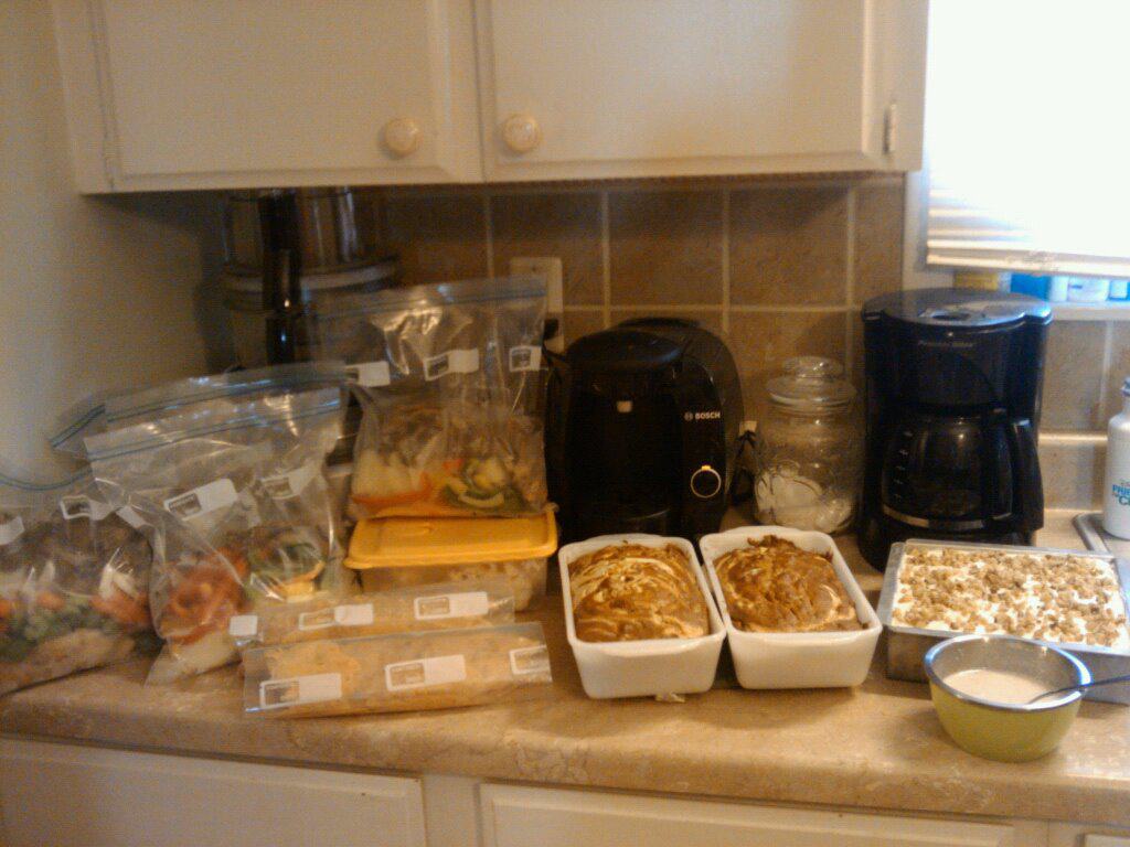 Kitchen counter full of freezer meals and healthy groceries. 