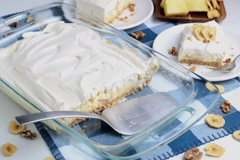 No fail banana pineapple dessert recipe. Pie slices are placed on white plates.