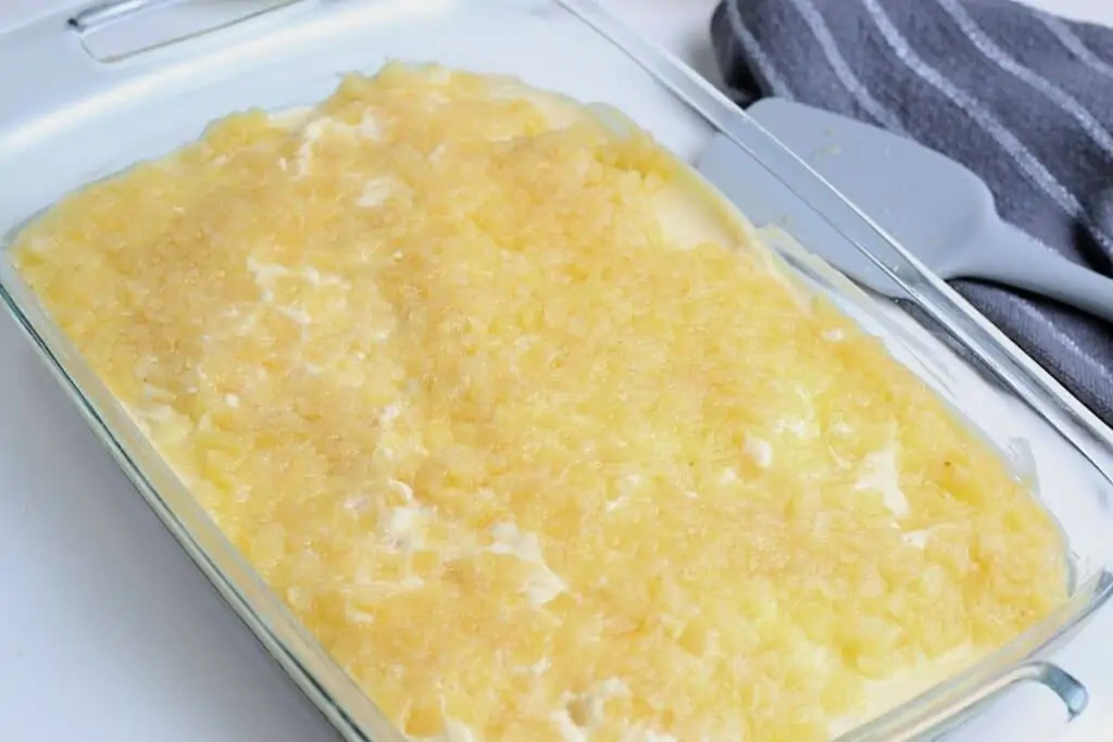 Crushed pineapples on top of the vanilla pudding and mixture. 