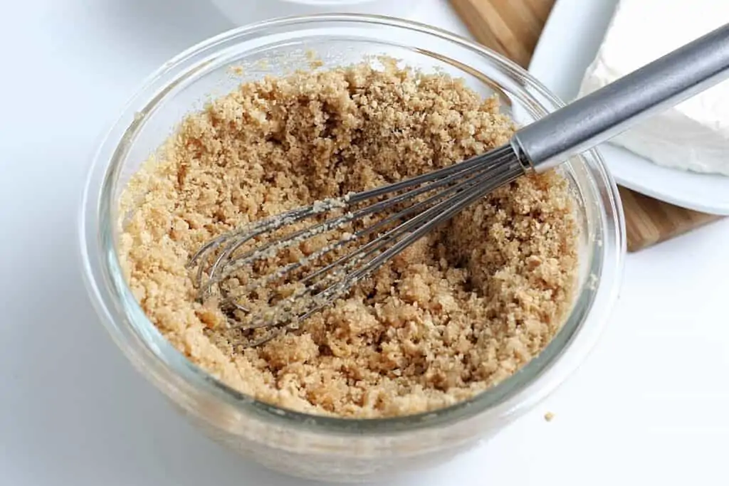 Graham cracker crust smashed in a bowl.