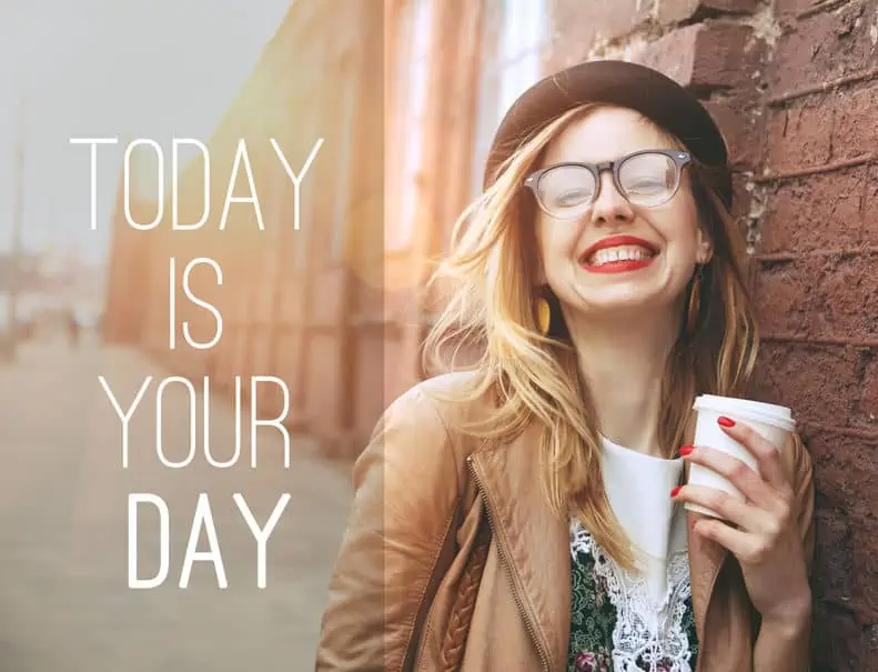 A woman holding a sign posing for the camera drinking a cup of coffee for National Coffee Day 