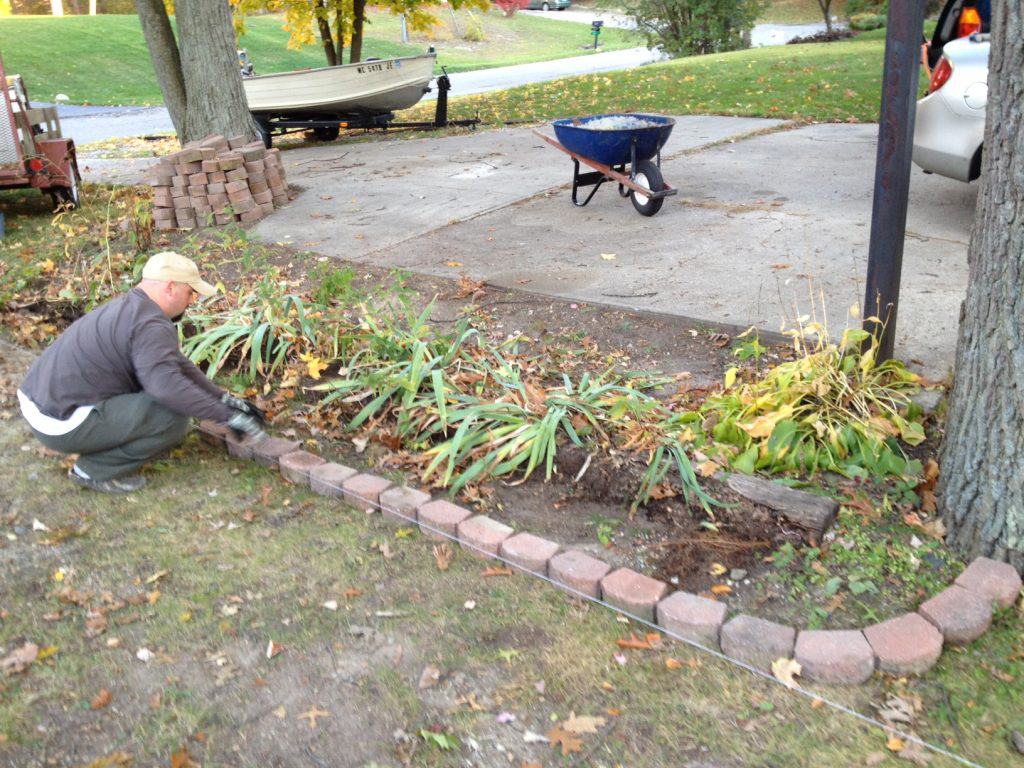A person working on the plants in the garden.