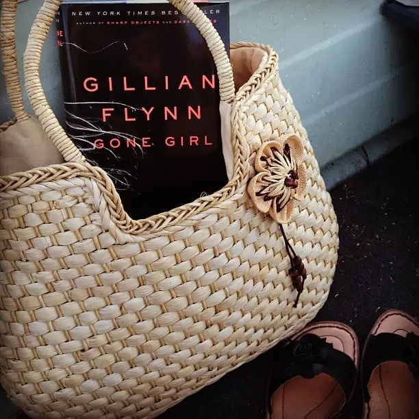 Gillian Flynn\'s \"Gone Girl\" book in a wicker purse.