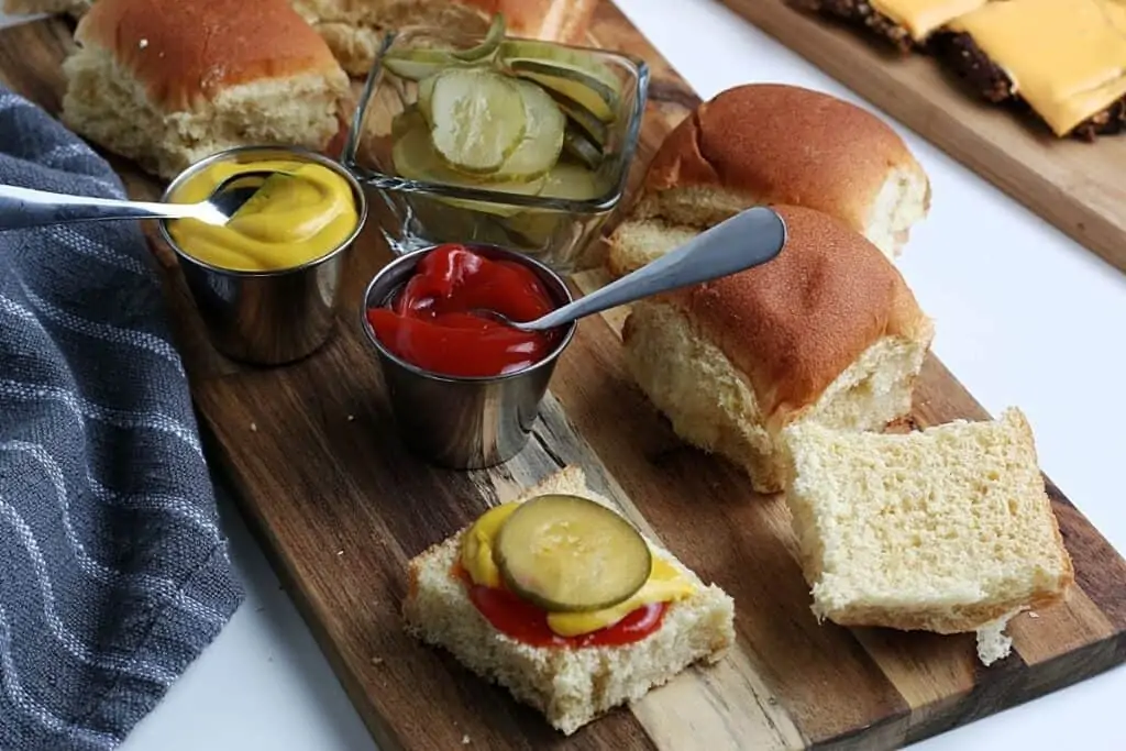 Sliced pickles and bread for sliders.