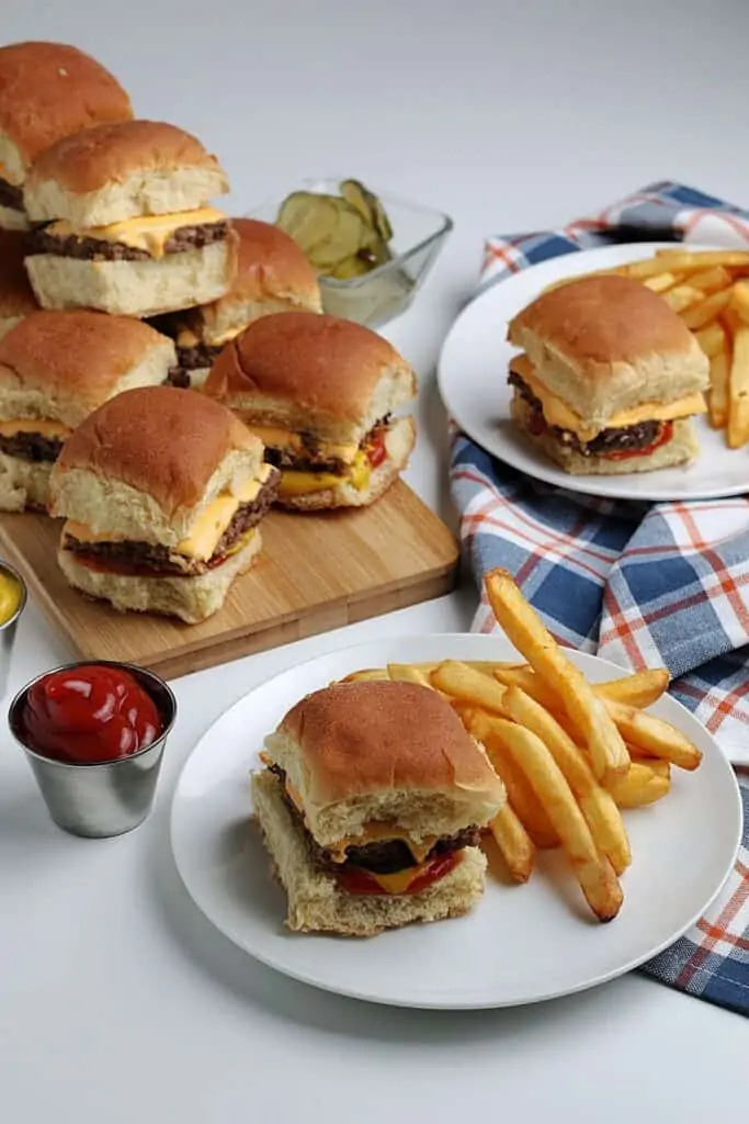 Sliders with a plate of French fries.