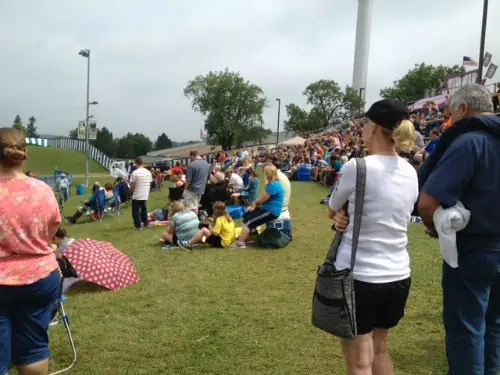 A group of people that are standing in the grass