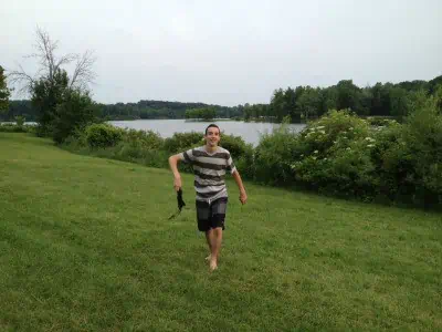 A person standing on a lush green field