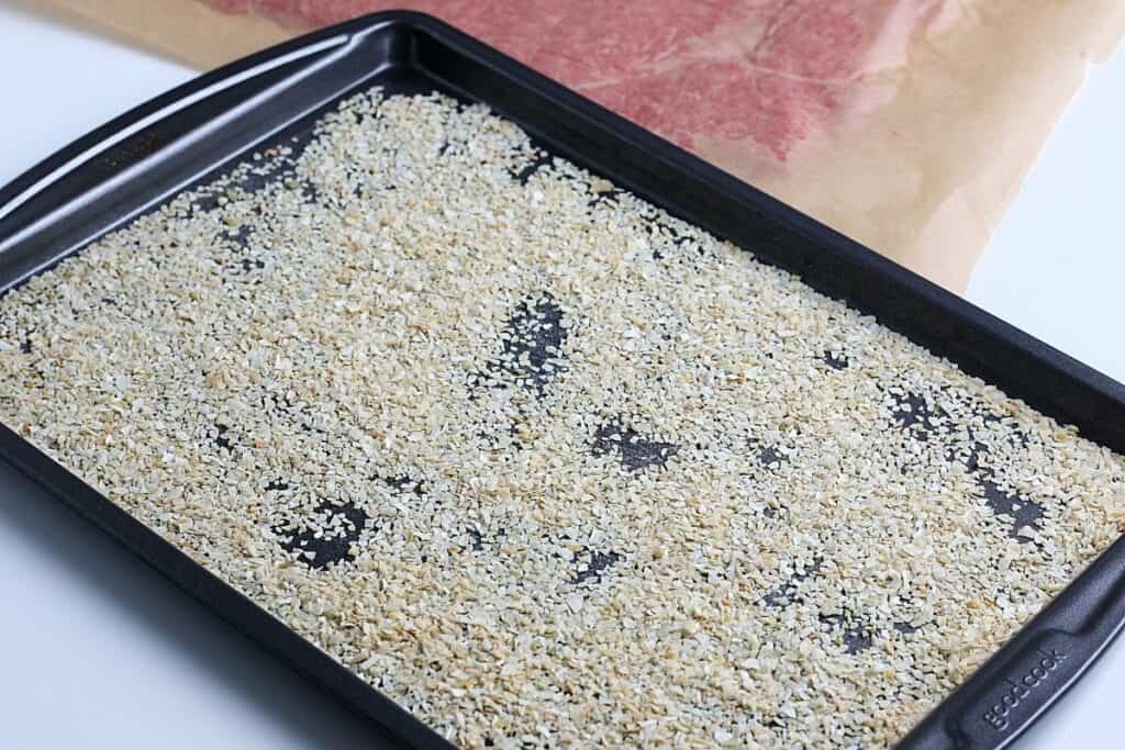Sprinkle your dried onion flakes onto the bottom of your pan. 