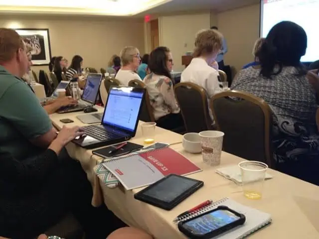 A group of people sitting at a table using laptops