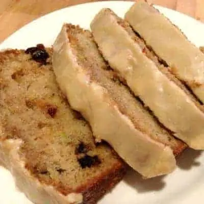 Individual slices of cranberry zucchini bread with frosting.