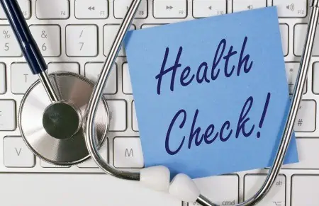 Health check sign on keyboard with stethoscope. 