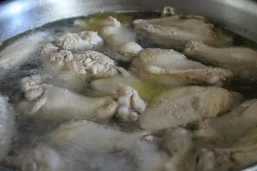 Cook chicken in a pot of boiling water for Best Oven Baked Buffalo Wings Recipe.
