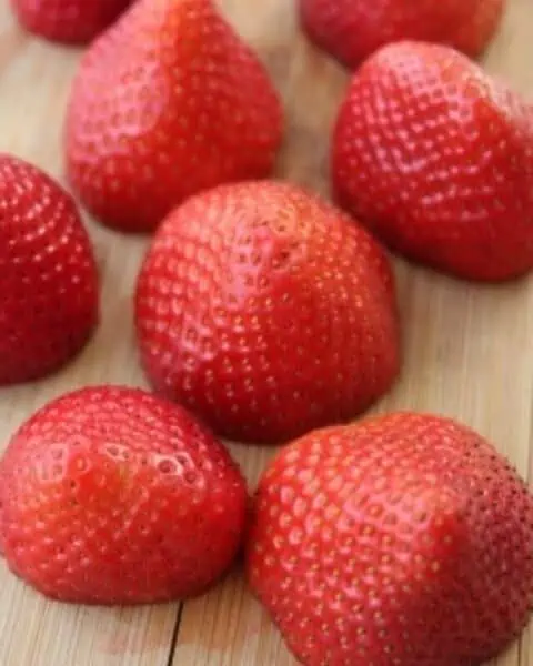 Plate of cut strawberries.