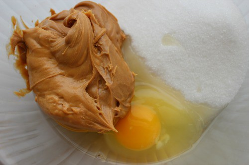 peanut butter, egg, and sugar in a bowl.