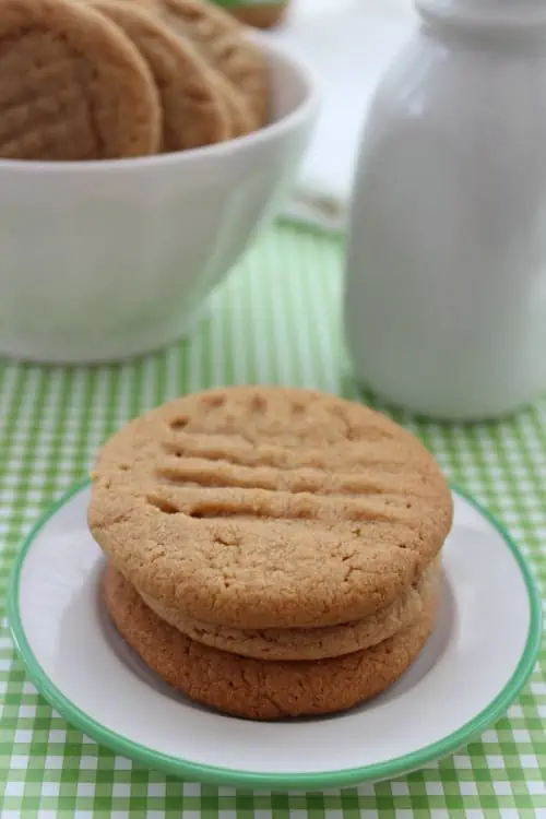 A close up of a plate of food and a cup of coffee, with Peanut butter cookie