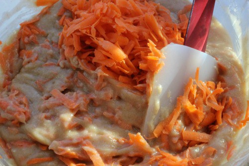 Shredded carrots with cream cheese mixture for carrot cake.