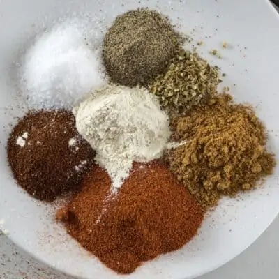 different herbs on a white plate