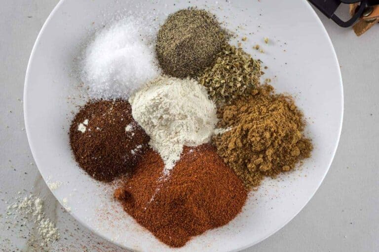 different herbs on a white plate