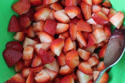 A bowl of cut strawberries.