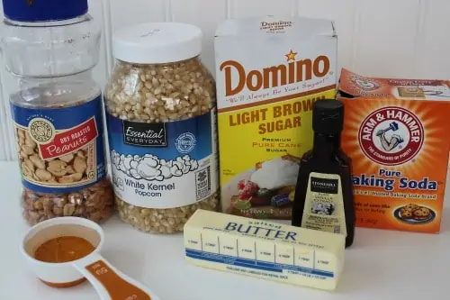 A close up of popcorn, brown sugar, butter, vanilla, baking soda and peanuts