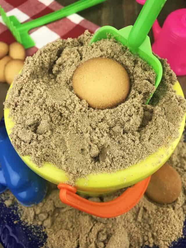 A yellow beach sand pail with pudding inside.
