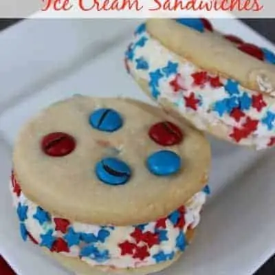 A white plate with homemade ice cream sandwiches with M&Ms, and red and blue star sprinkles.