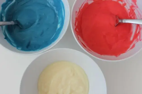 Three bowls of red, white, and blue pudding.