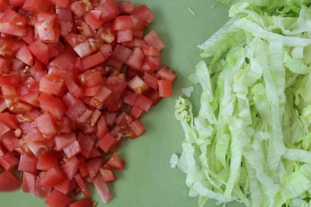 Tomatoes and lettuce chopped for taco Toppings