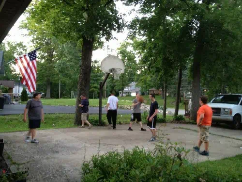 a family playing basketball together.