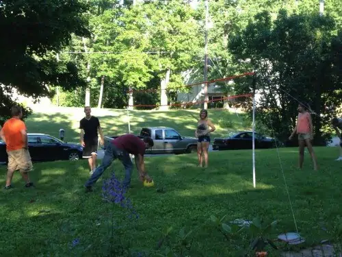 a family playing volleyball together.