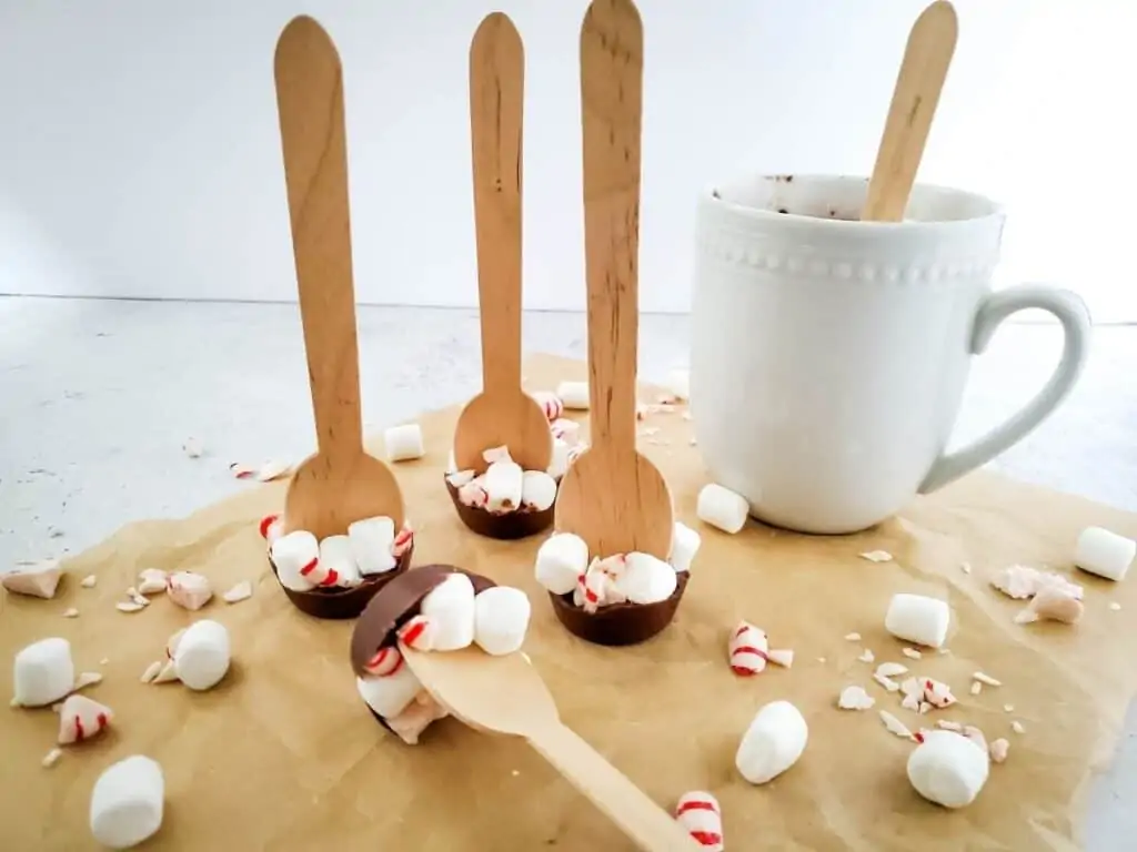 Homemade Christmas hot chocolate spoons with peppermint bark and marshmallows.