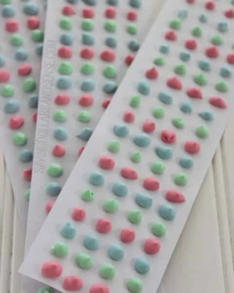 Long papers of homemade candy dots in different colors.