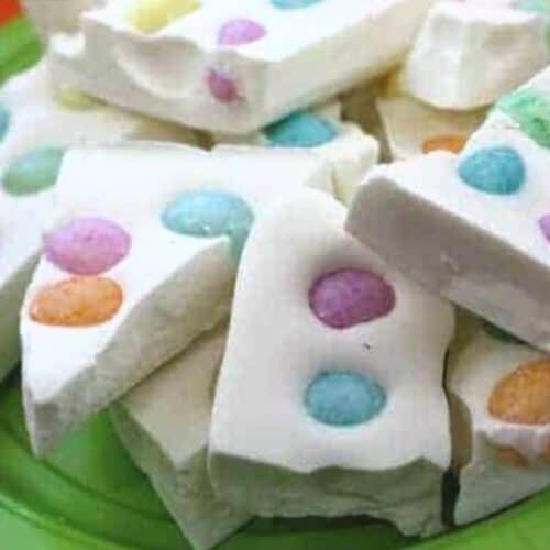 Plateful of white chocolate bark with jelly beans.