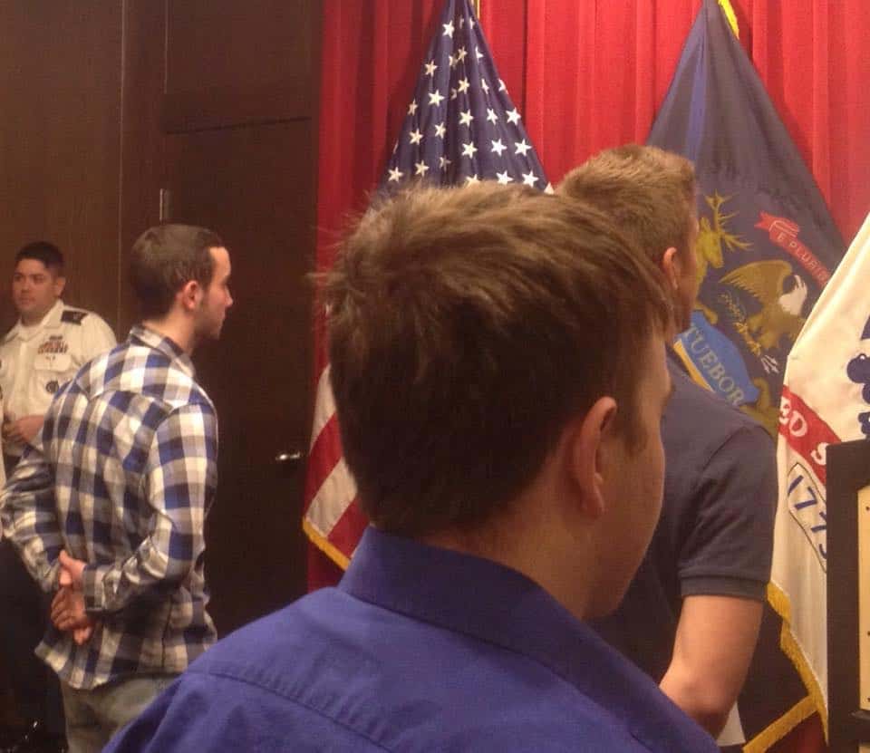 A young man enlists in the military and attends an information night.