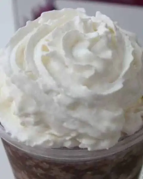 A perfect whip cream swirl on top of an iced drink.