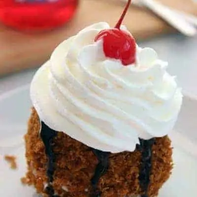 No Fry Fried Ice Cream on a plate with whip cream and a cherry on top.