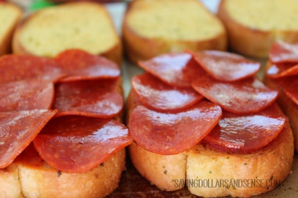 Pepperoni slices laying on top of slices of bread.
