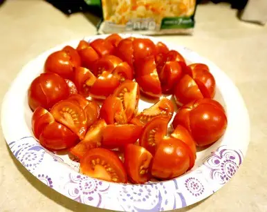 A plate of tomatoes cut up for serving.