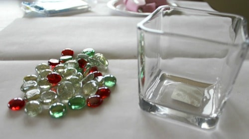 A glass on a table with light pebbles on the side.