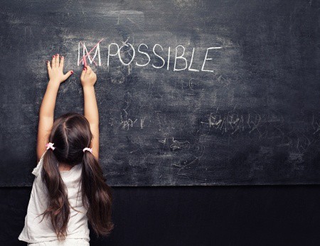 Little girl creating the word \"Possible.\"