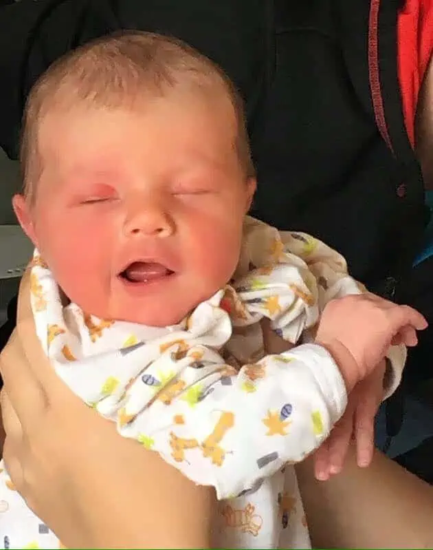 A person holding a new baby