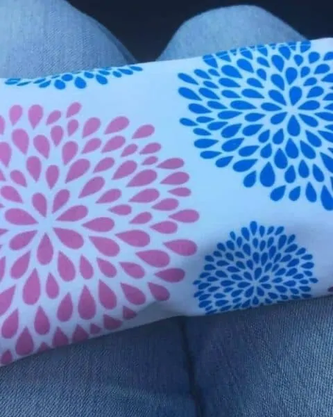A blue and pink floral case for essential oils.