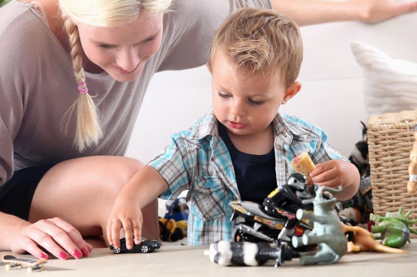 mother and child playing with toy cars