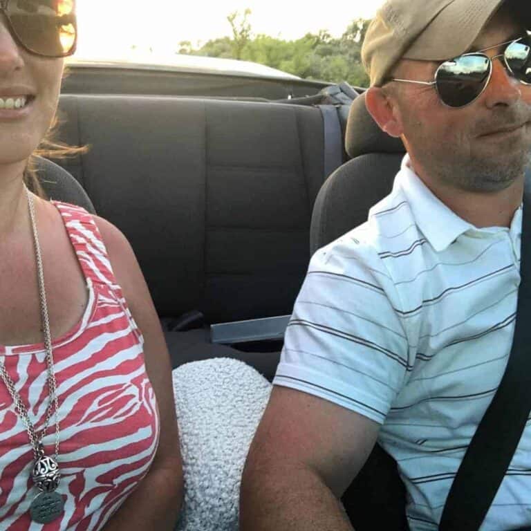 A happy couple driving.