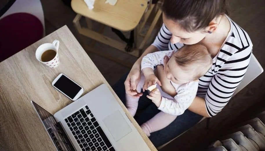 young mother in home office with computer and her daugher