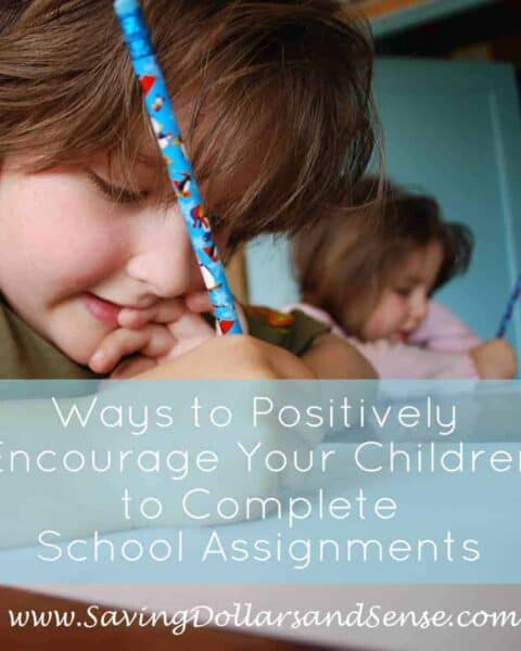 A little boy writing with a pencil and completing a school assignment.