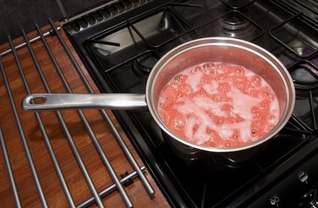 home made strawberry jam being cooked up on stove.