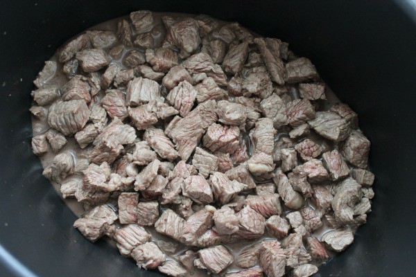 Cooked beef in a slow cooker.